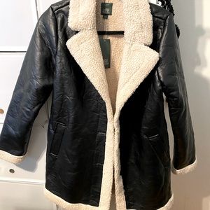 Size small black jacket with faux fur/low shag. NWT, never worn.